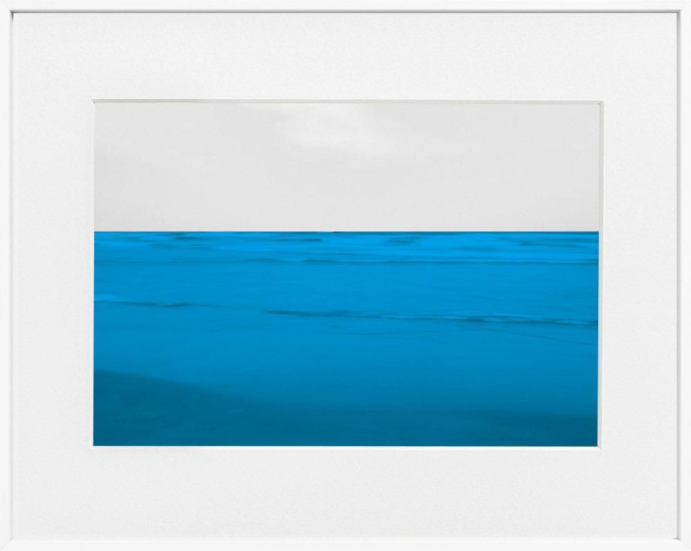 A limited edition museum-quality photograph featuring a abstract blue and white horizontal image, with a certificate of authenticity.