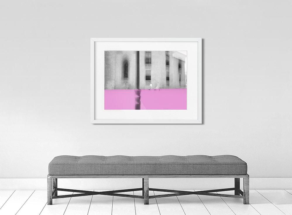 A limited edition museum-quality photograph featuring a grayscale urban scene with a pink horizontal band, titled 'Valencia, 2019'. The image includes architectural elements and a sense of depth.