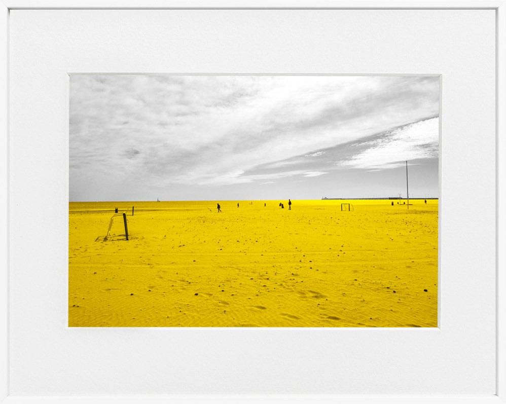 A limited edition museum-quality photograph featuring a predominantly yellow landscape with a body of water and a cloudy sky, titled 'Cabañal, 2019'.