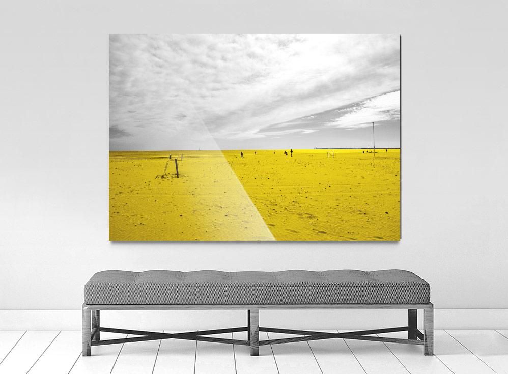 A limited edition museum-quality photograph featuring a predominantly yellow landscape with a body of water and a cloudy sky, titled 'Cabañal, 2019'.