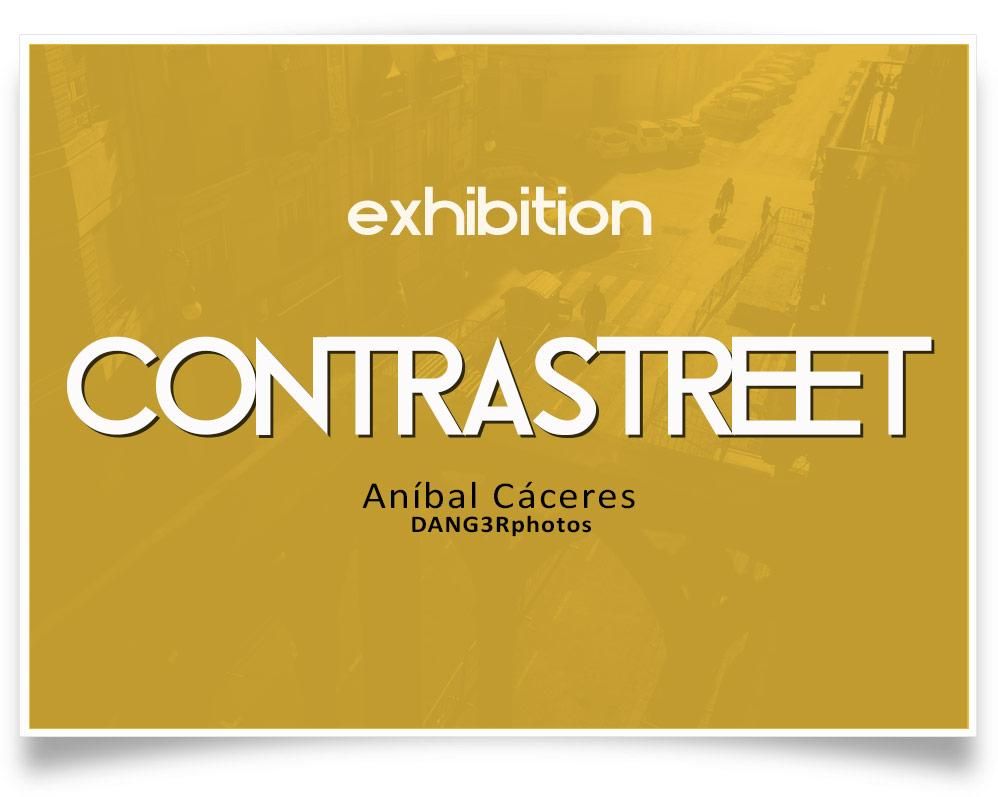 Large white and black text over a yellow-tinted aerial street scene with faint silhouettes of people and parked cars in the background.